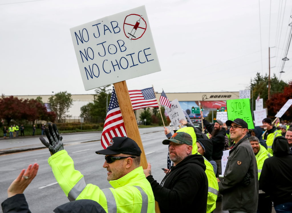 Biden team defends worker vaccine rule, wants challenges combined into single case