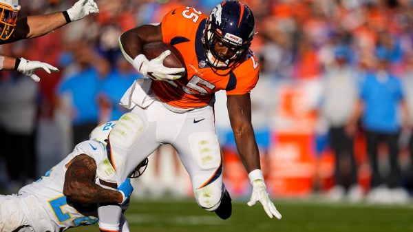 Denver Broncos’ Melvin Gordon displays on time with the NFL group